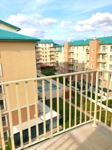 a balcony of a apartment complex with buildings at Adina Cosmopolis in Ştefăneştii de Jos +11 photos