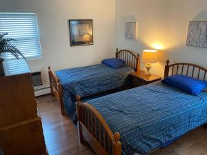 a bedroom with two beds and a lamp and a window at Narberth - Fire Works, Train 2 Philly, Town Center in Narberth