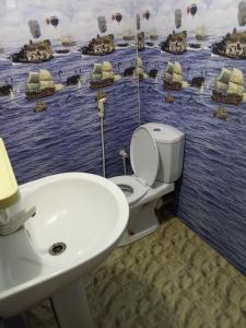 a bathroom with a toilet and a sink at Pranu House in Nilaveli