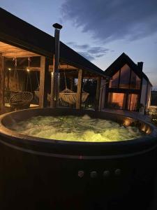 a large hot tub on a patio at night at Polny Raj in Ciotusza Stara +10 photos