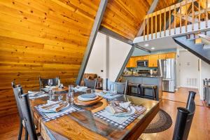 a dining room with a large wooden table with chairs at Nakai Trail 4-br A-frame Firepit Game Rm Sauna in Mountainaire