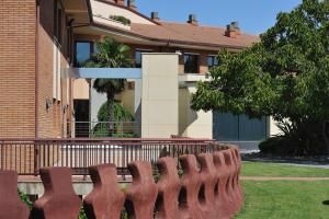 a row of brown chairs in front of a building at Hotel Els Noguers in Manresa