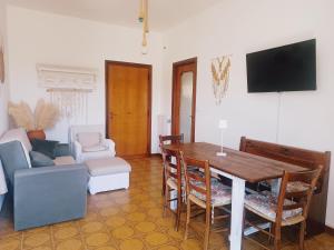 a living room with a table and a couch at Casa Artigena in Rapallo