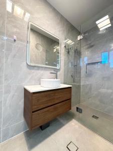 a bathroom with a sink and a shower at Cozy Bedroom with Private Bathroom and Toilet Close to Train Station Airport in Revesby