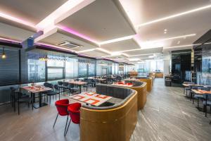 a restaurant with tables and chairs and a bar at Blue Ocean Hotel 4 in Incheon