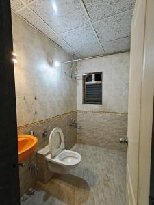 a bathroom with a toilet and a sink at 3BHK Spacious Villa in Pune +7 photos