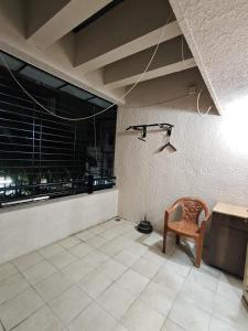 a room with a chair and a light on the wall at 3BHK Spacious Villa in Pune