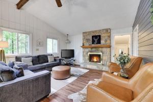 a living room with a couch and a fireplace at Pet Friendly Lake Retreat With Hot Tub & Fire Pit in Locust Lakes Village