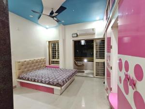 a bedroom with a bed in the middle of a room at 3BHK Spacious Villa in Pune