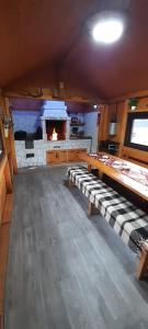 a kitchen with a fireplace and benches in a room at La Ianis in Vatra Dornei