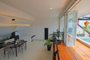a living room with a dining table and a swimming pool at Beautiful Penthouse w/ incredible views, pool, & cinema room! in Canggu