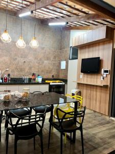 a dining room with a table and chairs in a kitchen at Casa, 01 Suíte, Ar-Cond, Área Gourmet e Garagem Ampla in Montes Claros
