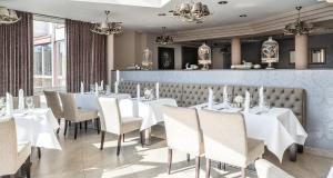 a dining room with white tables and chairs at Best Western Victor's Residenz-Hotel Rodenhof in Saarbrücken
