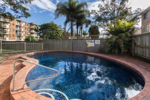 a swimming pool in a yard with a fence at Heritage 301 in Tuncurry