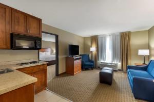 a hotel room with a kitchen and a living room at Comfort Inn & Suites Marion I-57 in Marion