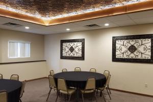 a room with a table and chairs and stained glass windows at Econo Lodge - Valley City in Valley City