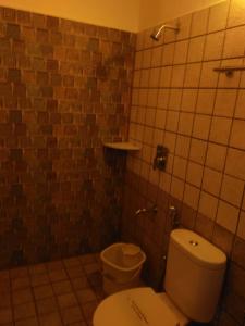 a small bathroom with a toilet and a sink at Esparan Heritage in Puducherry +29 photos