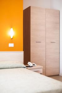 A bed or beds in a room at Hotel Villa Ombrosa