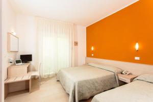 Postel nebo postele na pokoji v ubytování Hotel Villa Ombrosa