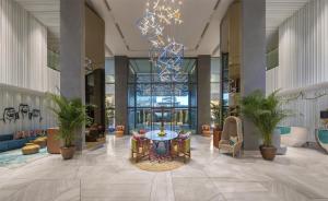 a lobby with a table and chairs in a building at Andaz Dubai The Palm, By Hyatt in Dubai