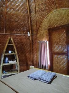 a room with a bed with a mirror and a door at Bale Gantar in Sembalun Lawang +66 photos