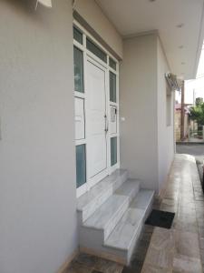 a building with a white door and some stairs at Maria's Studio No3 in Heraklion in Thérissos