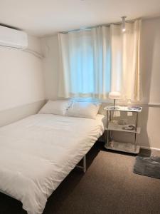 a small room with a bed and a window at nook Inn in Seoul