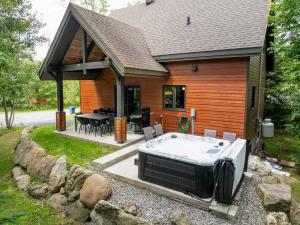 a house with a hot tub in the yard at Spa & Pool table - Ivy Cottage in Scott
