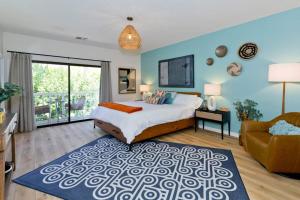 a large bedroom with a bed and a couch at Avocado Toast - Steps To Tennis, Pickleball, Golf in La Quinta +74 photos