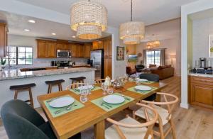 a kitchen and dining room with a wooden table and chairs at Avocado Toast - Steps To Tennis, Pickleball, Golf in La Quinta