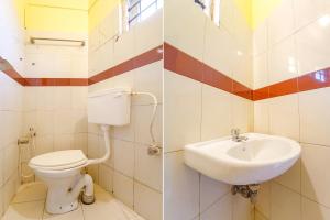 une salle de bain avec toilettes et lavabo dans l'établissement Ascot Hotel, à Cochin