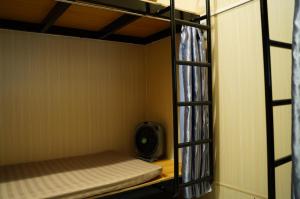 a small room with a bunk bed and a fan at An Mai homestay in Cao Bằng