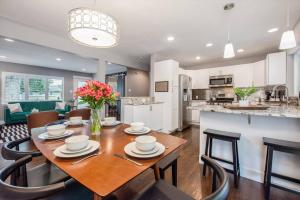 a kitchen and dining room with a table and chairs at Mid-mod Marvel Central Game Rmwet Bar Patio in Arvada