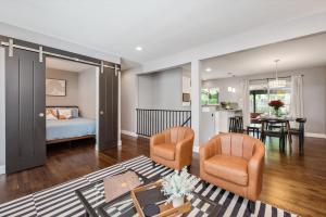 a room with a bed and two chairs and a table at Mid-mod Marvel Central Game Rmwet Bar Patio in Arvada