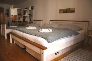 a large bed with two towels on top of it at Apartmán č.2 in Banská Štiavnica