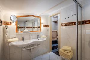 a bathroom with a sink and a shower at Boutique Appartments Gerlosperle in Gerlos +91 photos