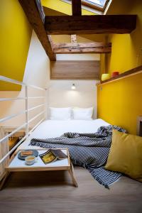 a bedroom with a white bed and a table at Cozy House Apartment Cluj Central in Cluj-Napoca