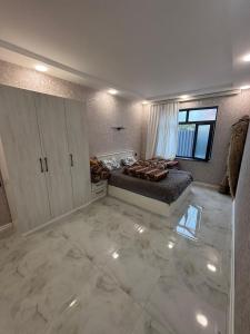 a large room with a bed and a window at Quba Villa in Quba