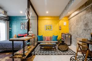 a living room with a bed and a couch at Double Studio with Balcony & Private Bath by Smile Loft in Ban Na Song