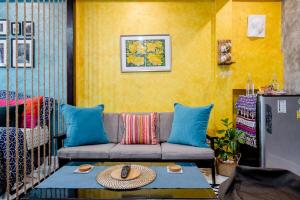 a living room with a couch and a table at Double Studio with Balcony & Private Bath by Smile Loft in Ban Na Song