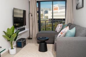 a living room with a couch and a window at Apartment in uMhlanga The Millennial in Durban
