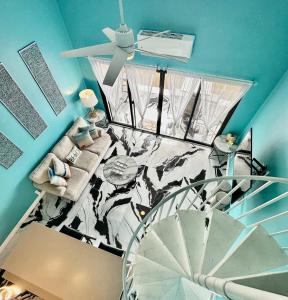 a living room with a spiral staircase and a ceiling at Luxury 2bed 2bath Condo In Downtown Red Hook in St Thomas