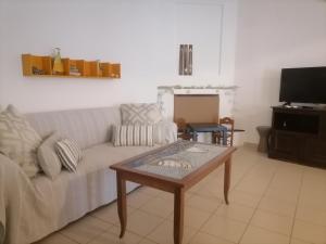 a living room with a couch and a coffee table at On the beach in Koutsounari