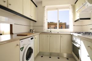 a kitchen with a washer and dryer in it at Riurau Home - Primera línea in Calpe