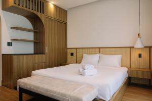 a bedroom with a bed with a towel on it at Tuberose - Victoria Villa in Dien Ban +45 photos