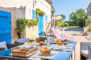 a table with food and bread on a patio at Chez Jacques in Saint-Martin-de-Fraigneau