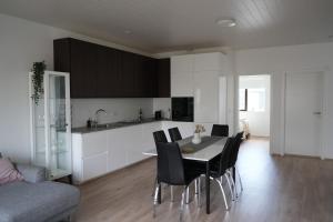 a kitchen and dining room with a table and chairs at Cozy apartment in Grindavík in Grindavík