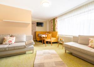 a living room with two couches and a table at Chalet Ferienhaus Hubertus in Schladming