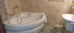 a white tub in a bathroom with a sink at Elit Pamporovo Apartments in Pamporovo +11 photos