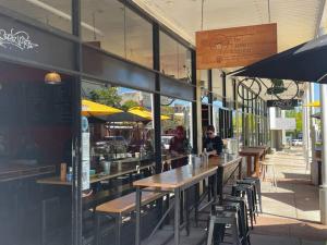 a restaurant with tables and chairs and people sitting at it at Magical Mcatee W Pool And King Bed in Fremantle